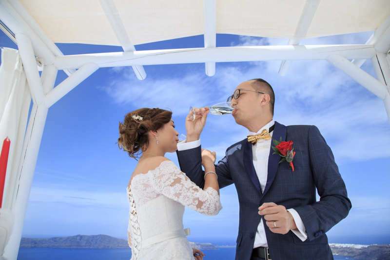 Bride groom drink champagne outdoor after wedding ceremony